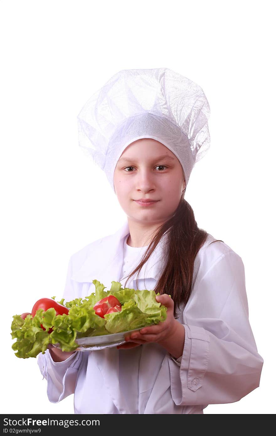 Portrait of teenager girl in chef uniform with vegetarian food. Isolated on white by lighting setup. Portrait of teenager girl in chef uniform with vegetarian food. Isolated on white by lighting setup