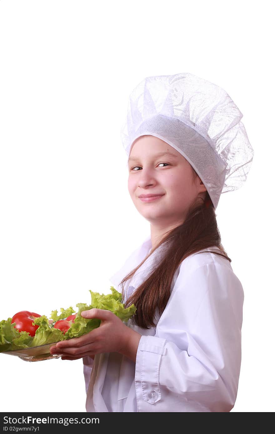 Portrait of teenager girl in chef uniform with vegetarian food. Isolated on white by lighting setup. Portrait of teenager girl in chef uniform with vegetarian food. Isolated on white by lighting setup