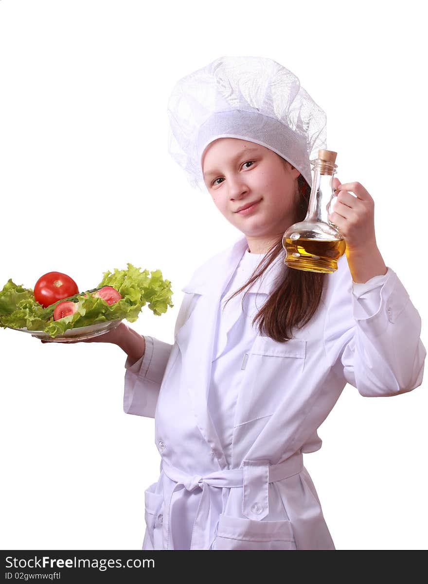 Portrait of teenager girl in chef uniform with vegetarian food. Isolated on white by lighting setup. Portrait of teenager girl in chef uniform with vegetarian food. Isolated on white by lighting setup