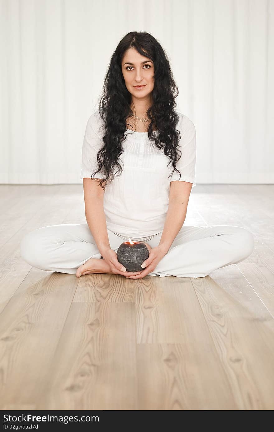 Young woman with long black curly hair doing yoga. Young woman with long black curly hair doing yoga