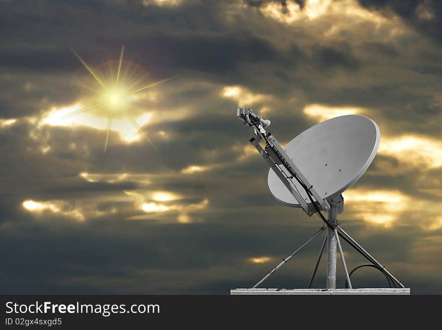 Satellite dish with sun and clouds in the background. Satellite dish with sun and clouds in the background.