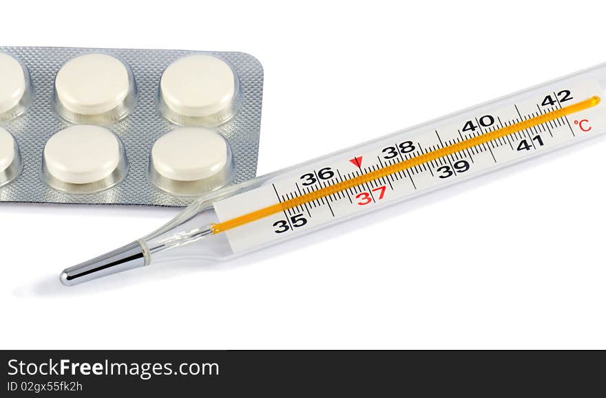 Glass clinical thermometer and pills isolated on white with light shadow. Includes clipping path.