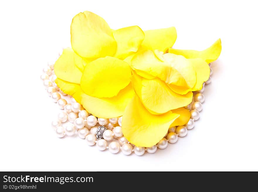 Yellow roses petals and white pearls isolated on white background. Yellow roses petals and white pearls isolated on white background