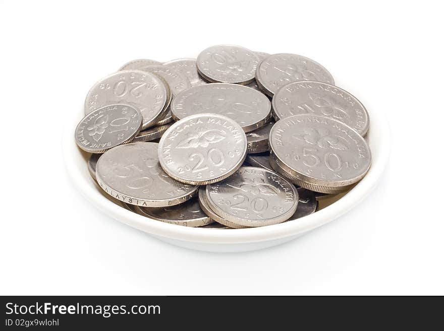Malaysia coins ten, twenty and fifthy cents in plate with isolated white background. Malaysia coins ten, twenty and fifthy cents in plate with isolated white background