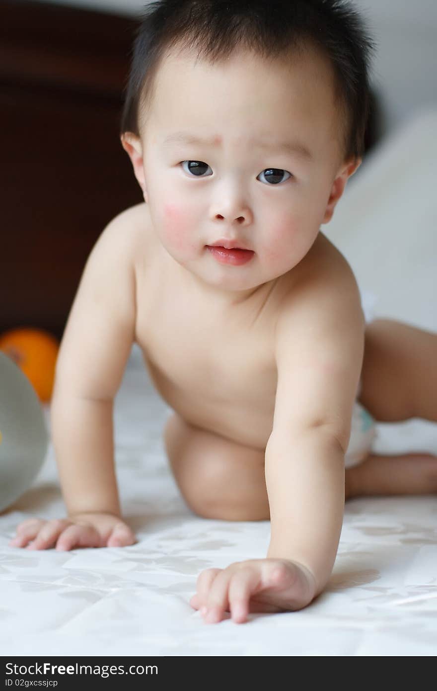 This is a photo of a one year old boy who was being attracted by the lens on the camera. This is a photo of a one year old boy who was being attracted by the lens on the camera.