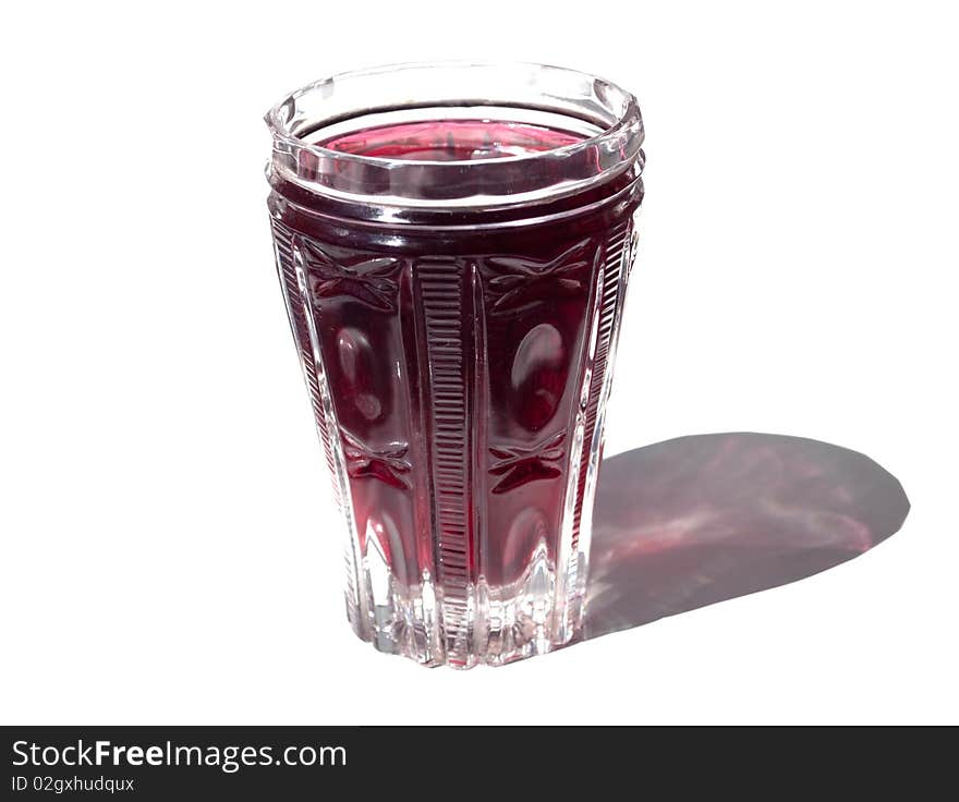 Crystal glass with a fruit drink on a white background