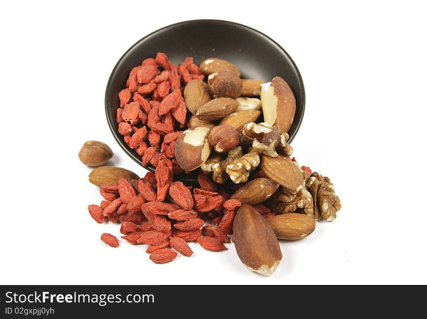 Goji Berries and Nuts Spilling from a Bowl