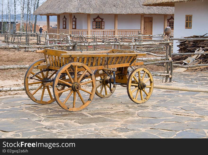 Old wooden cart near house. Old wooden cart near house