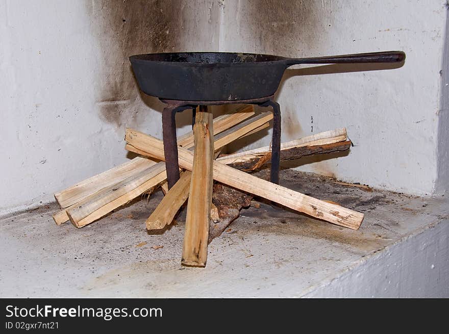 Old frying pan above a wood