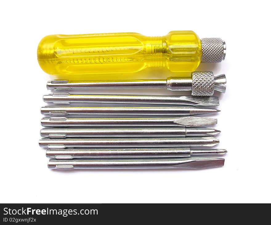 A yellow screw driver set with various attachments isolated on white.