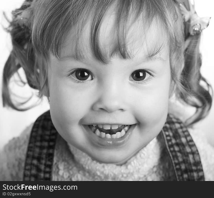 It is black a white portrait of the little girl. It is black a white portrait of the little girl