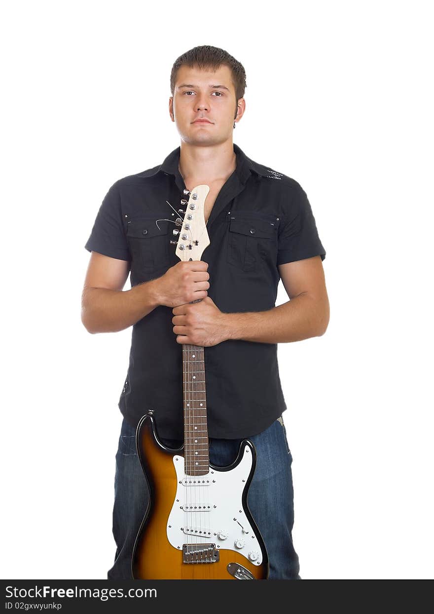 The serious beautiful guy with a guitar in a dark shirt with a guitar in hands. The serious beautiful guy with a guitar in a dark shirt with a guitar in hands