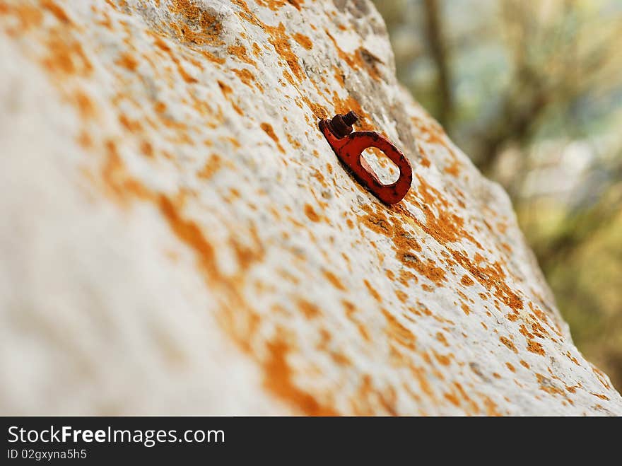 Old climbing anchor on the rocks