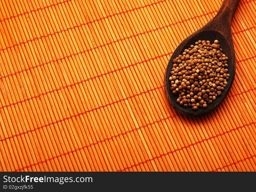 Pepper corns over orange bamboo mat