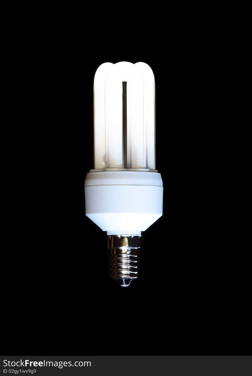 Energy saving compact fluorescent lightbulb isolated on black background. Energy saving compact fluorescent lightbulb isolated on black background