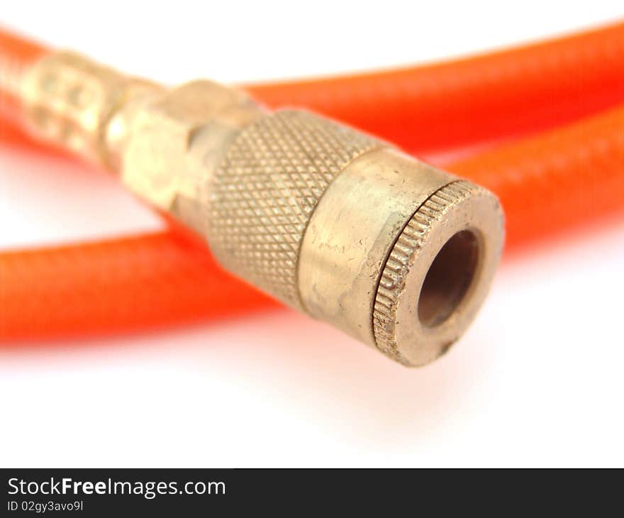 Orange hose with brass colored fitting isolated over white. Orange hose with brass colored fitting isolated over white