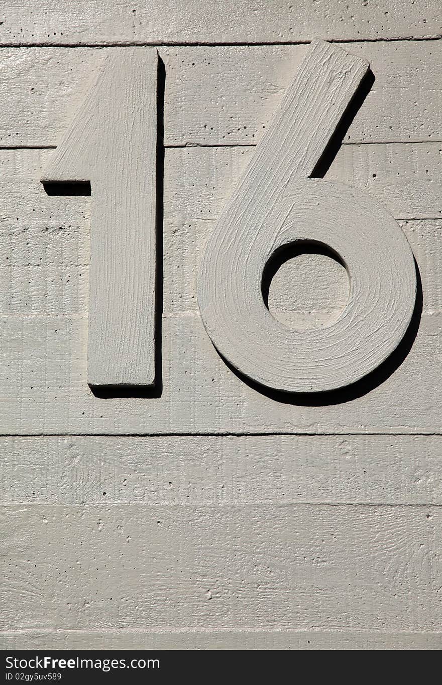 Number sixteen on a concrete surface textured wall. Number sixteen on a concrete surface textured wall