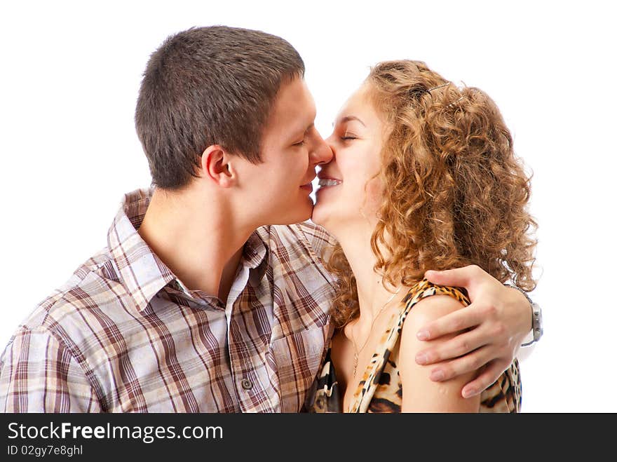 Young couple kissing isolated over white background