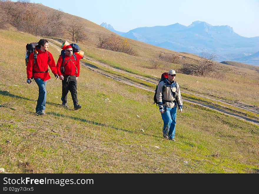 Hikers group walking in spring mountains