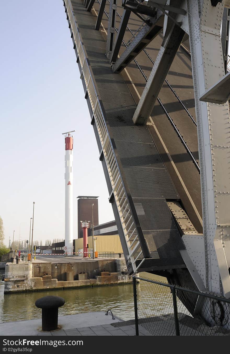 A lock bridge rises so ships can pass in the harbor