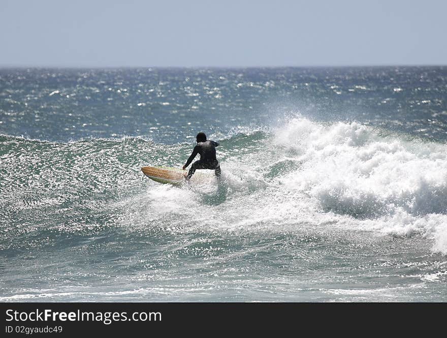 Surfer with a black suit in the wave. Surfer with a black suit in the wave