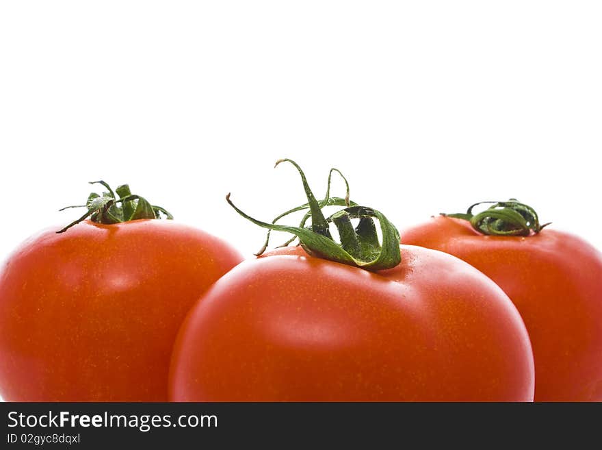 Three red tomatoes isolated on white. Three red tomatoes isolated on white