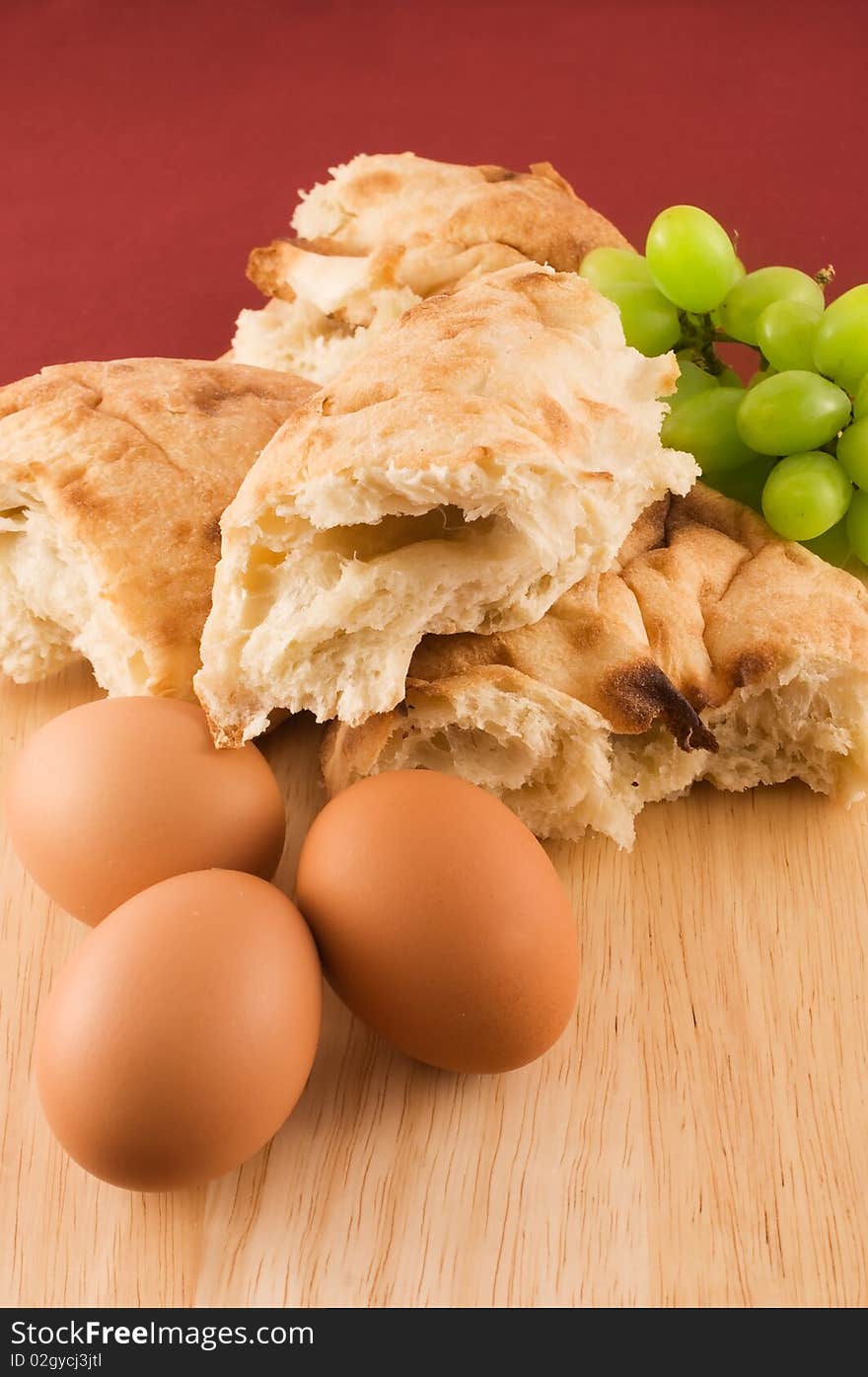 Fresh bread with eggs and grapes