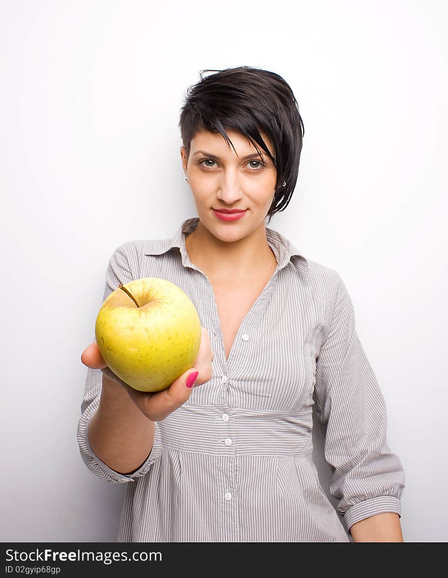 Young girl offering a yellow apple. Young girl offering a yellow apple