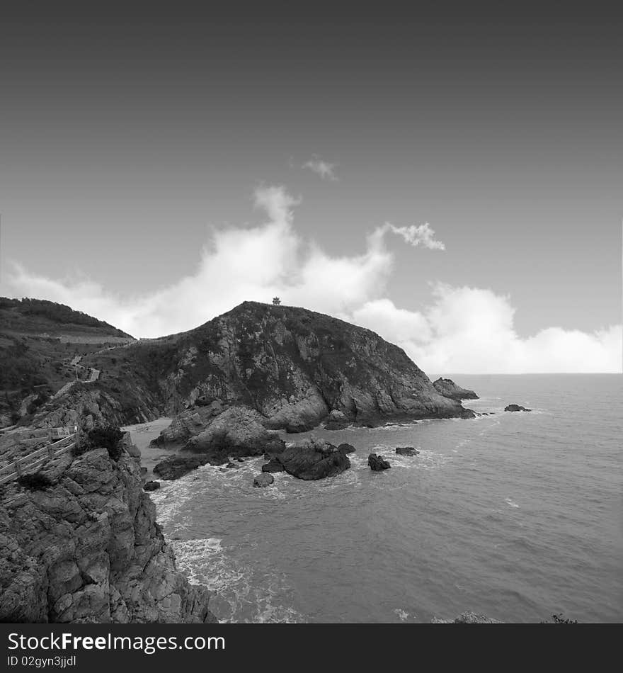 Reef in sea on sky background. Reef in sea on sky background