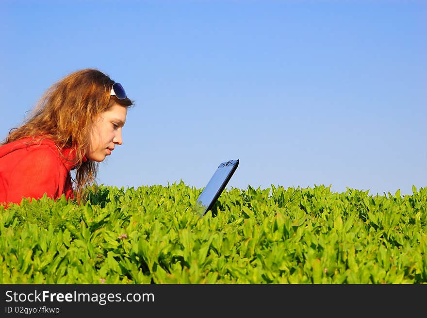 The beautiful girl with the laptop in the field. The beautiful girl with the laptop in the field