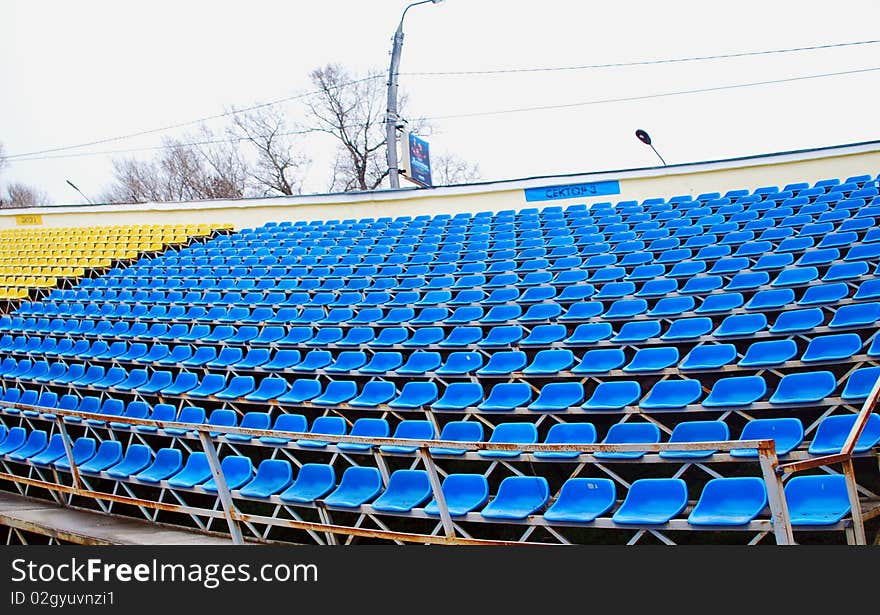 The Blue and Yellow Seats on an Empty Soccer stands