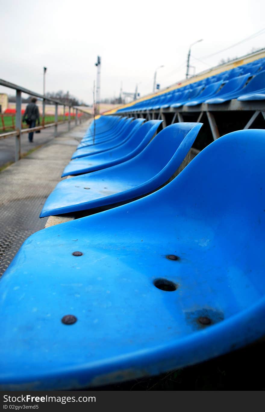 The Blue Seats in the Empty Stadium Stands. The Blue Seats in the Empty Stadium Stands