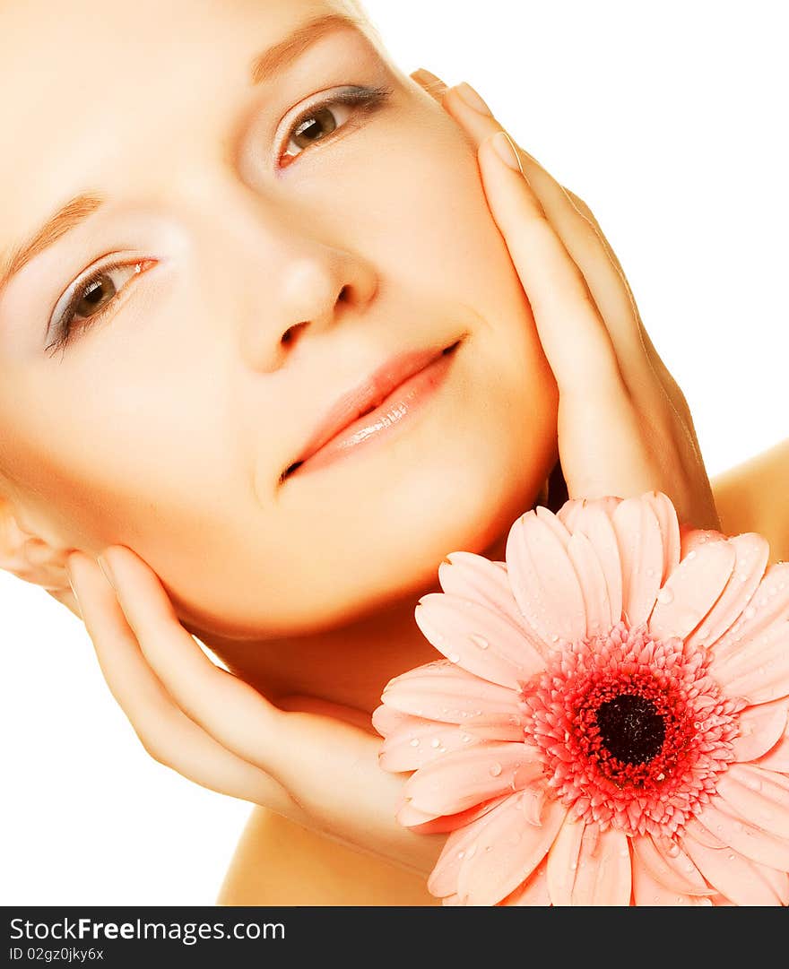 Beautiful young woman with gerber flower isolated on white background