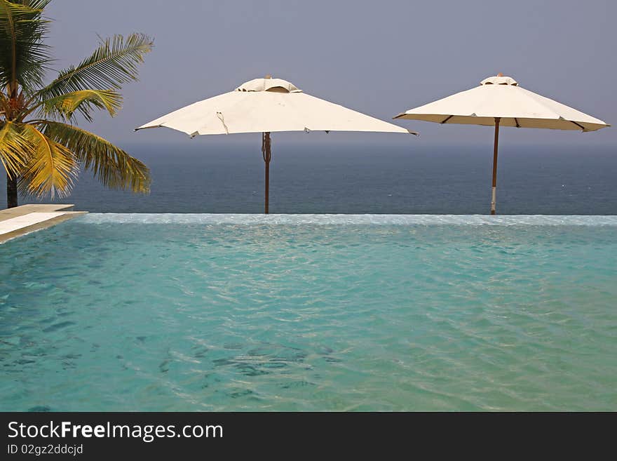 View across the infinity pool of the Leela Kempinski hotel in Kovalum, Kerala. View across the infinity pool of the Leela Kempinski hotel in Kovalum, Kerala