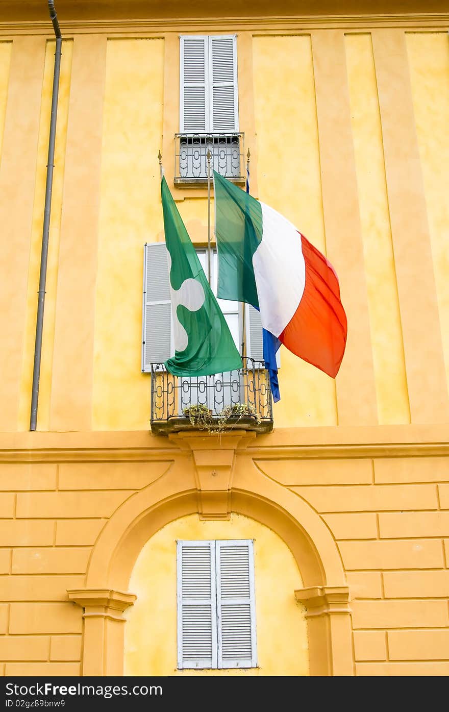 Picture of a building with Italian flag and Regione Lombardia flag. Picture of a building with Italian flag and Regione Lombardia flag