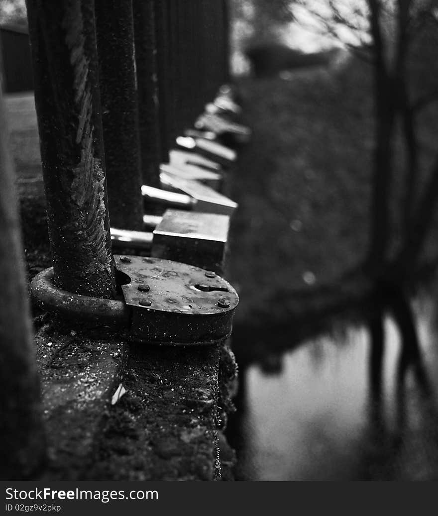 The Set of Locks on Bridge Railing Over a River Made Couples in Love