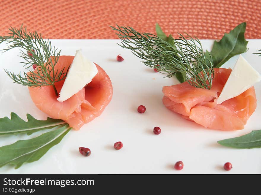 Smoked salmon rolls with butter, rocket and wild fennel. Smoked salmon rolls with butter, rocket and wild fennel