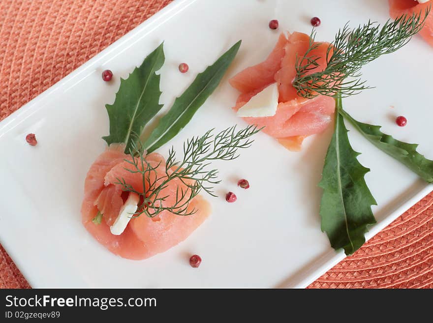 Smoked salmon rolls with butter, rocket and wild fennel. Smoked salmon rolls with butter, rocket and wild fennel