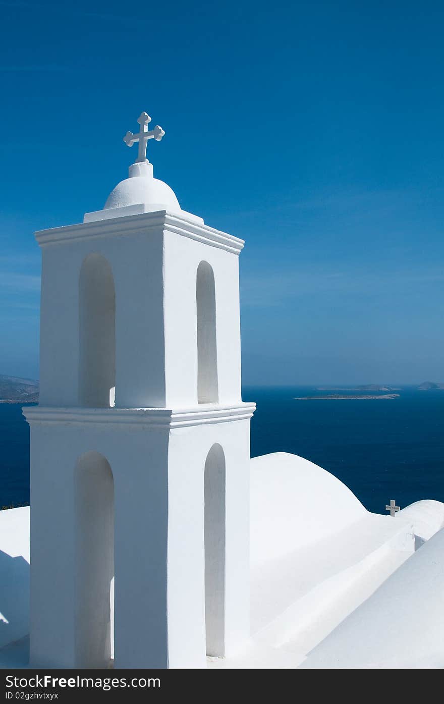 Greek church in santorini greece with a cross