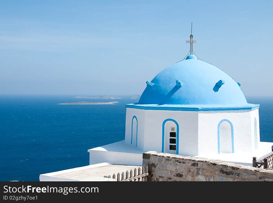 Greek church in santorini greece with a cross