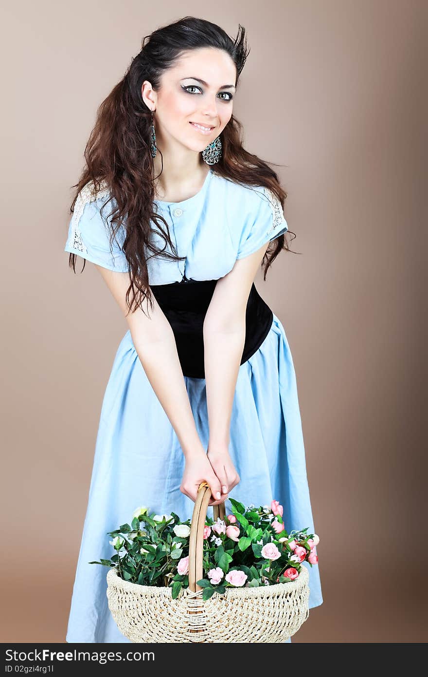 Shot of a beautiful young woman with a basket of flowers. Shot of a beautiful young woman with a basket of flowers.