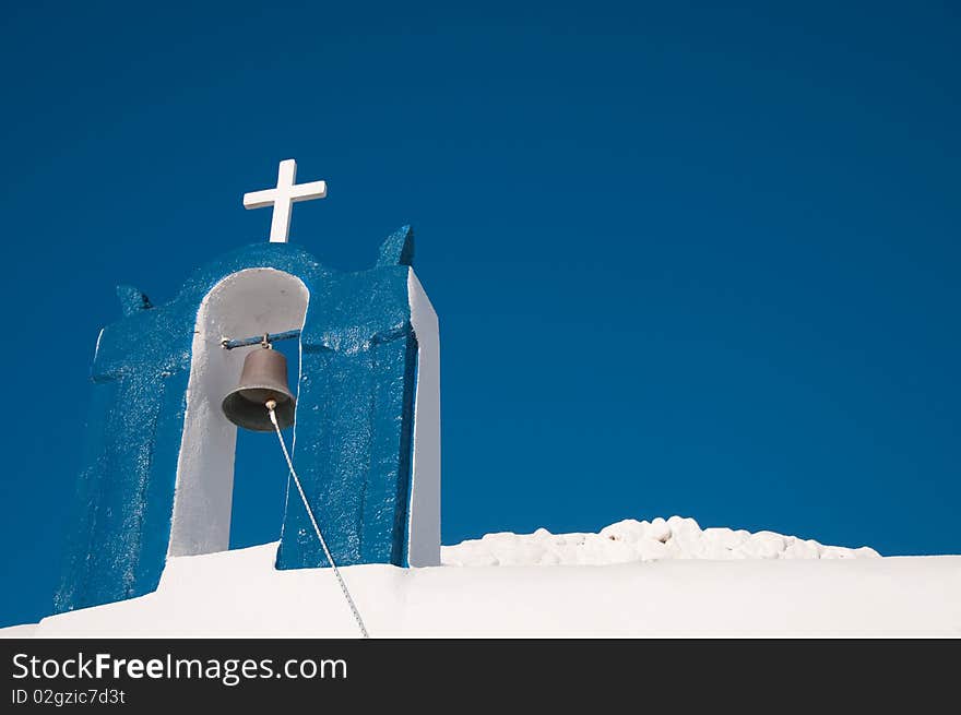 Greek church in santorini greece with a cross