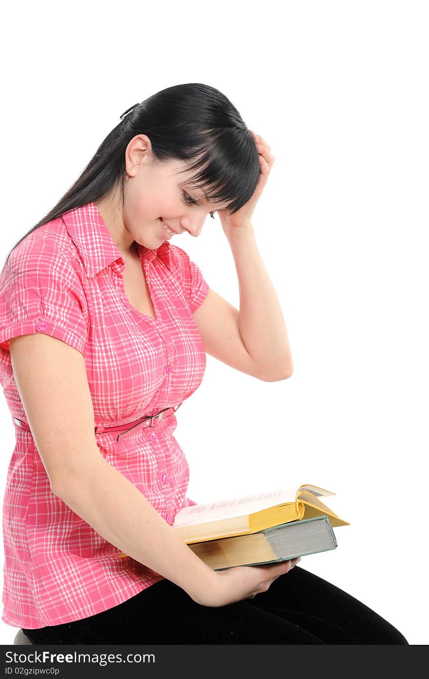 Young girl with long hair reads and thinks above the book on a white background. Young girl with long hair reads and thinks above the book on a white background