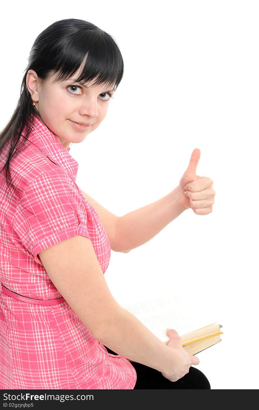 Young woman with thumbs ok; with book; isolated on a white background