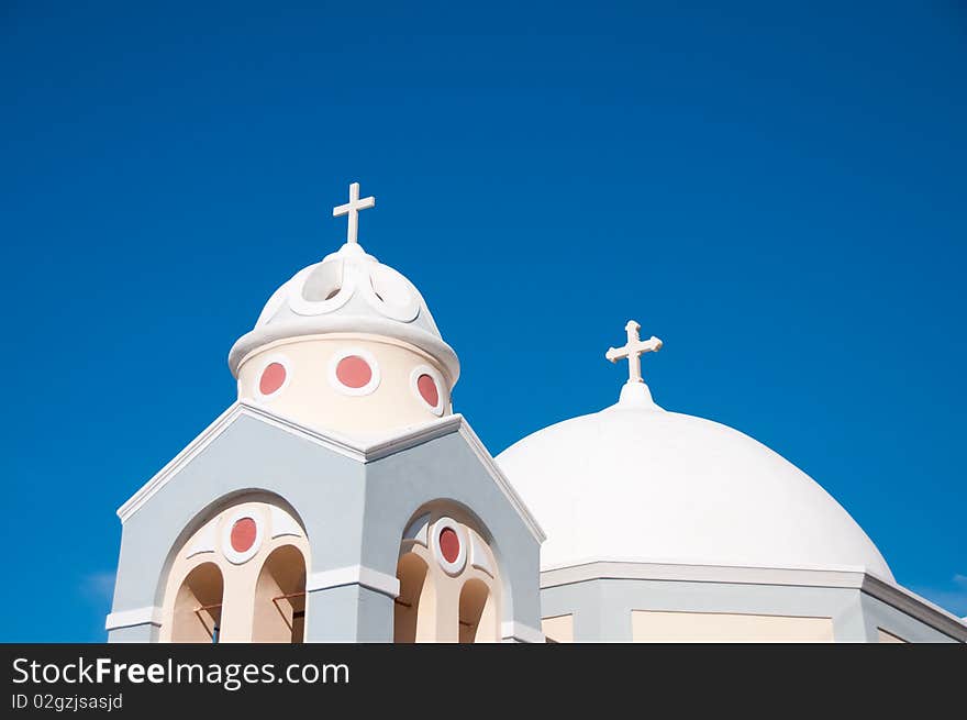 Greek church in santorini greece with a cross