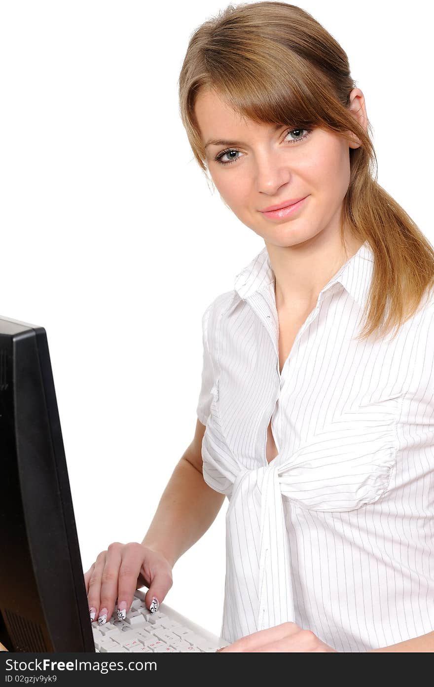 Business woman portrait smiling in front of her desktop computer. Business woman portrait smiling in front of her desktop computer.