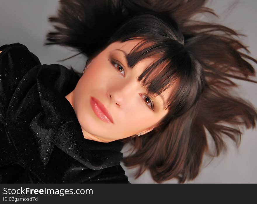 The young lady on the Grey background in studio