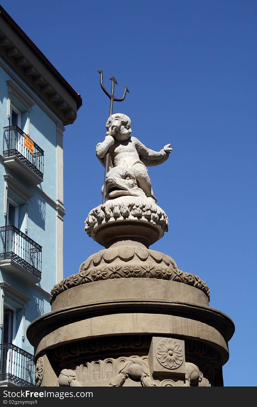 Statue of a child with a trident that decorates a source(fountain) of Pamplona, Navarre, Spain. Statue of a child with a trident that decorates a source(fountain) of Pamplona, Navarre, Spain.