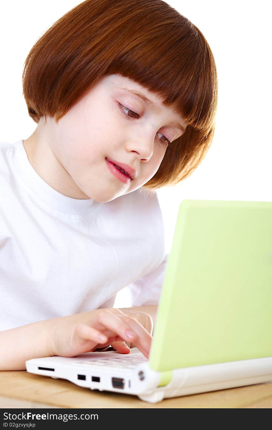 Little girl using laptop over white