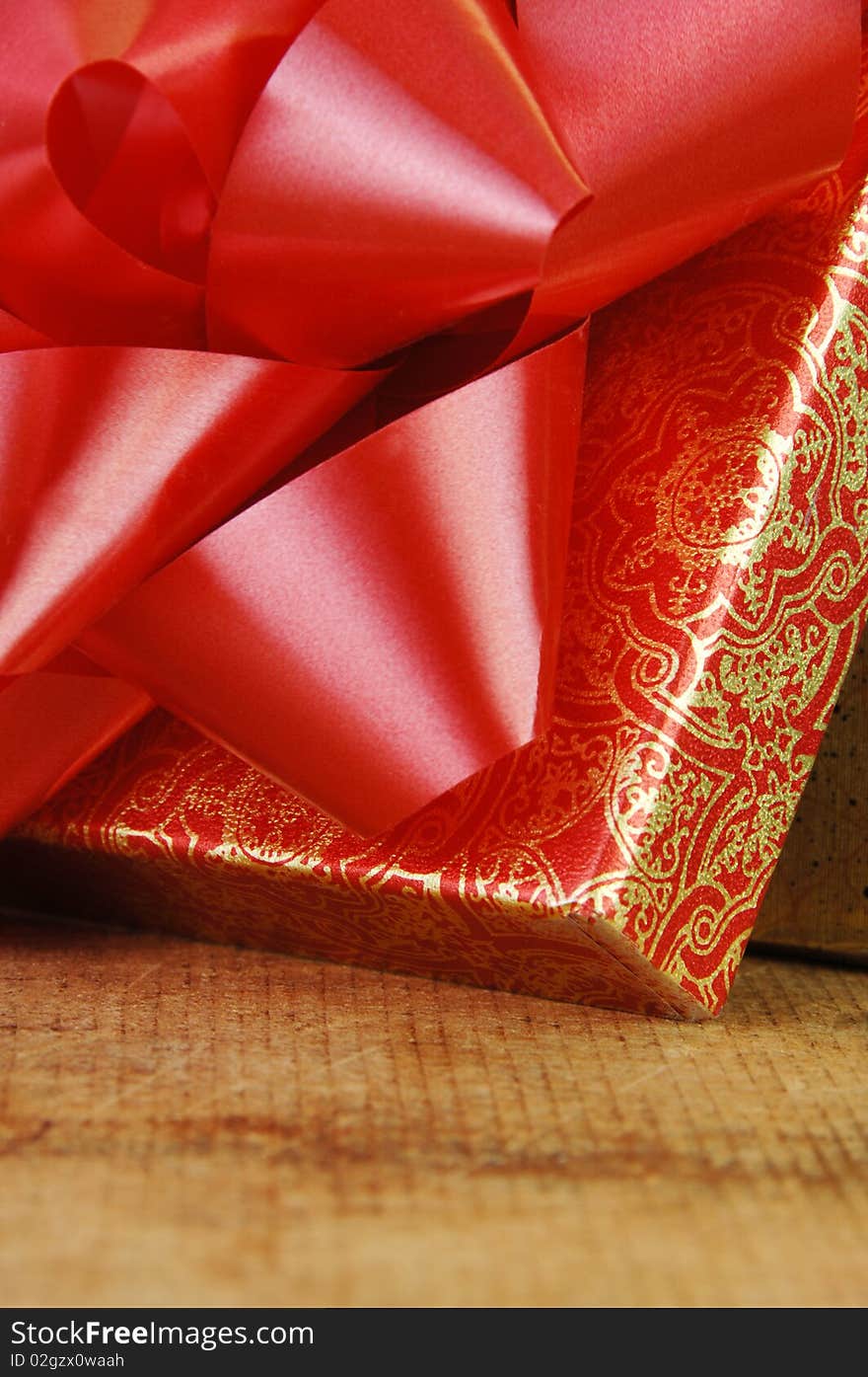 Red bow on opened gift box close up. Red bow on opened gift box close up.